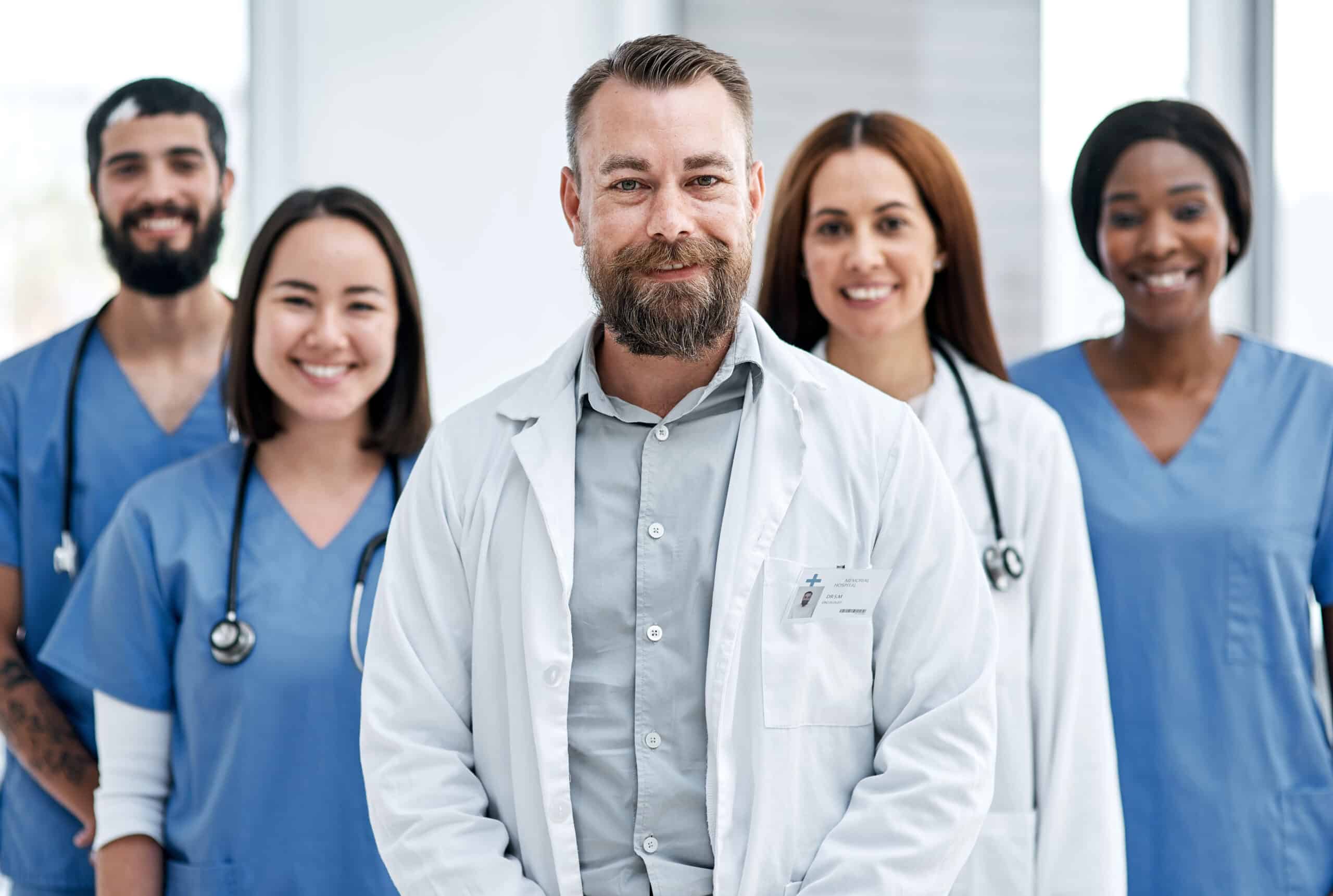 Portrait of a group of medical practitioners standing together in a hospital.